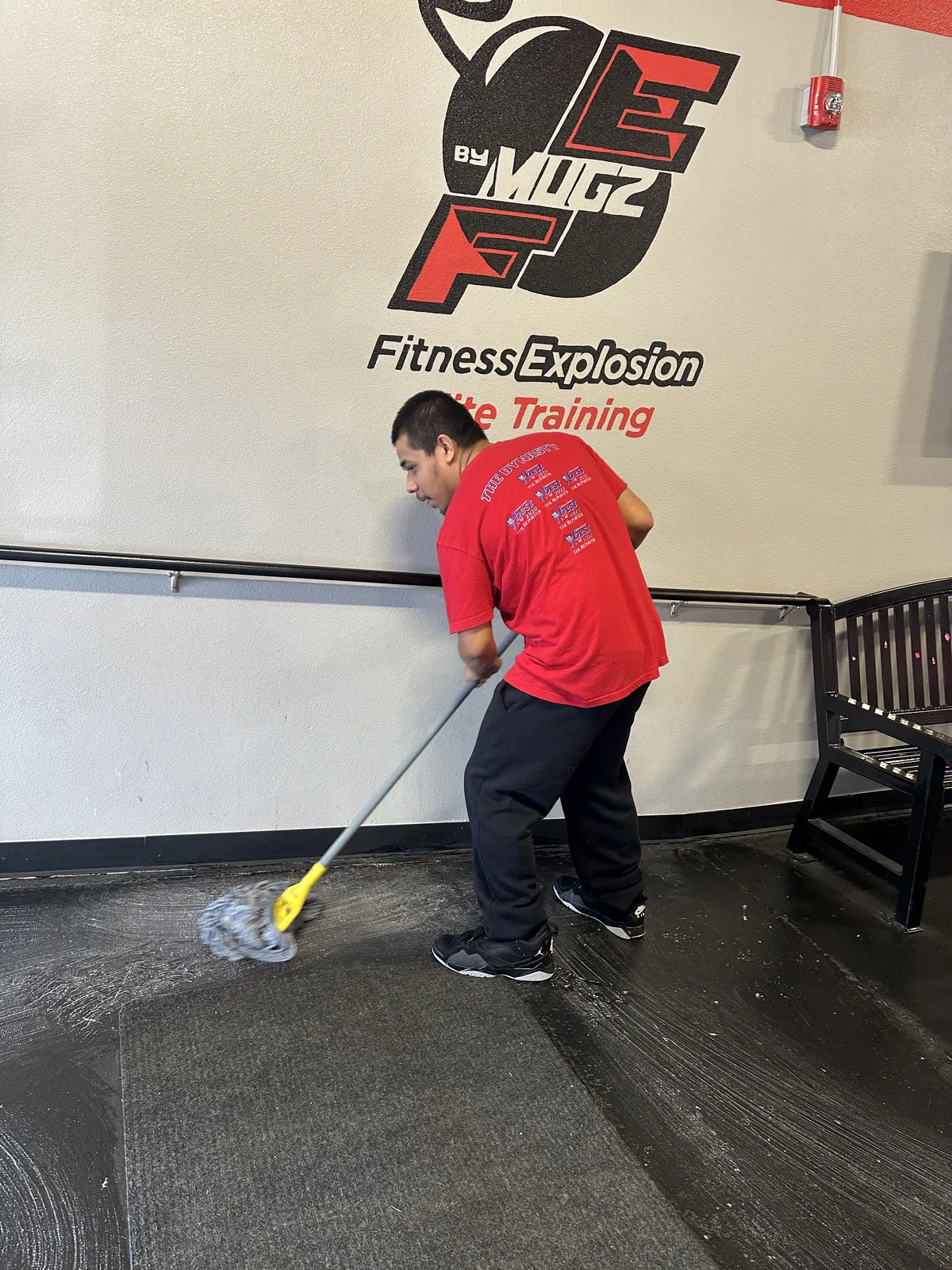 Staff maintaining spotless gym — cleanliness is our #1 review mention